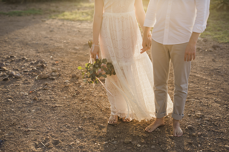 Heiraten am Strand mit den Füssen im Sand. Brautpaar boho